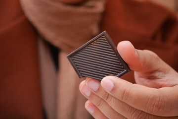 Closeup of woman eating chocolate candy ,