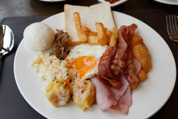 American breakfast with ham bacon toast fried rice on white plate