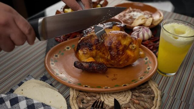 cutting a delicious roast chicken into a meal with a sharp knife