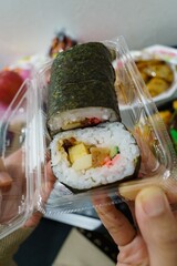 sushi roll in clear plastic food box
