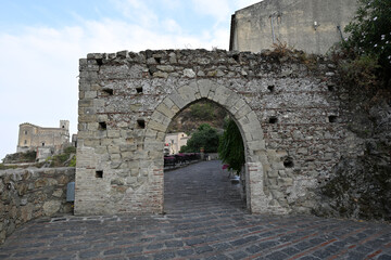 Obraz premium Stone arch gate in the italian city Savoca, Sicily, Italy