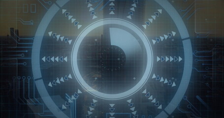 Image of arrow in loading circle and circuit board pattern over aerial view of modern buildings