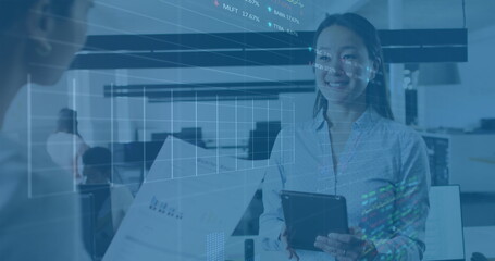 Image of multiple graphs and trading boards over diverse female coworkers discussing reports