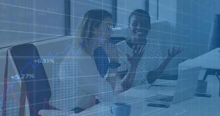 Image of multiple graphs with changing numbers, diverse female coworkers discussing on desk