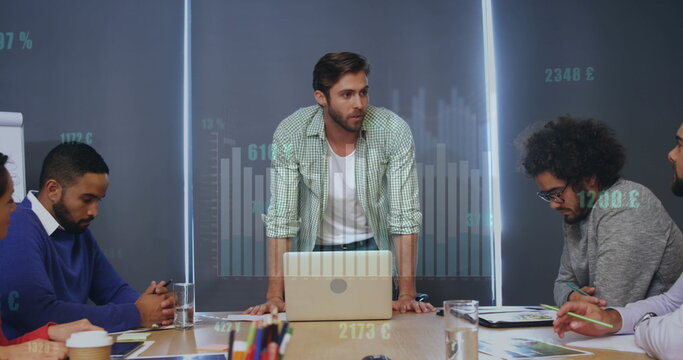 Image of graphs, changing numbers, currency symbols, diverse coworkers discussing reports - Powered by Adobe