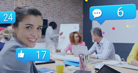 Image of multiple notification bars over smiling caucasian woman scrolling on digital tablet