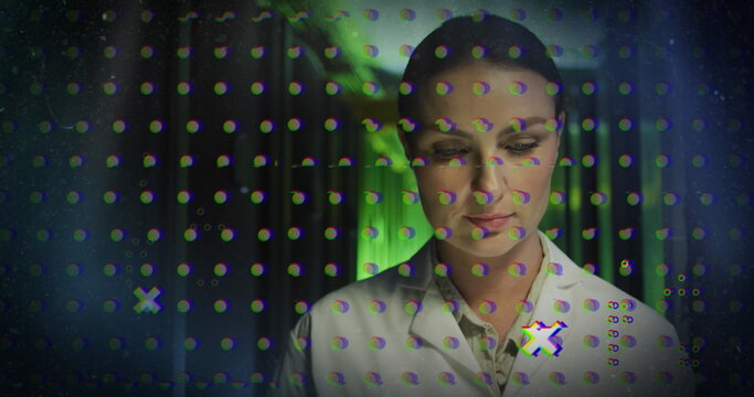 Image of abstract shapes against thoughtful caucasian female engineer working at server room - Powered by Adobe