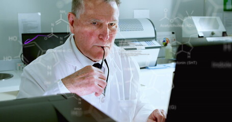 Image of medical data processing on caucasian senior male scientist using computer at laboratory