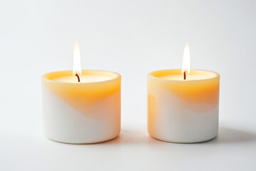 Two Burning Candles on a White Background