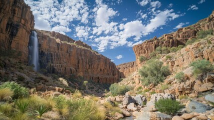 In the middle of the arid desert the illusion of a majestic waterfall can be seen cascading down a rugged cliffside.