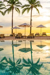 Umbrella and chair around swimming pool in resort hotel for leisure travel and vacation neary sea ocean beach © topntp