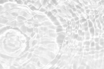White water with ripples on the surface. Defocus blurred transparent white colored clear calm water surface texture with splashes and bubbles. Water waves with shining pattern texture background.