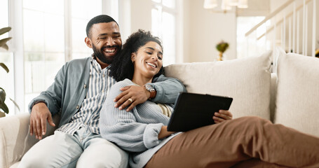 Couple, love and internet on sofa with tablet on streaming application for home entertainment,...