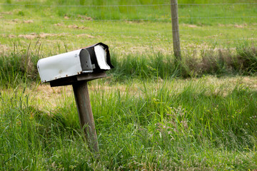 An image of two rural postal boxes on the side of an old country road. 