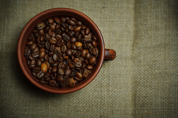 Coffee beans in a clay mug