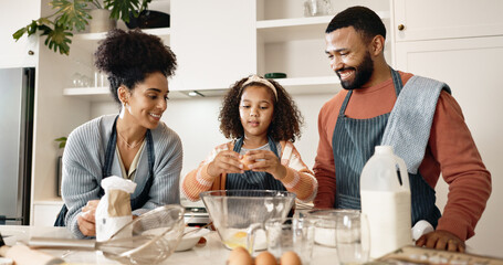 Family, child and baking in kitchen or home, cooking and learning together with parents in...