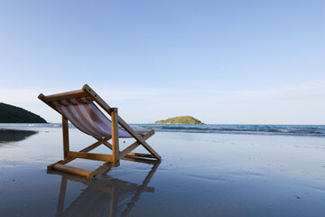Wooden lounge chairs on a beautiful tropical beach