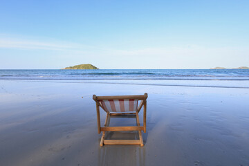Wooden lounge chairs on a beautiful tropical beach