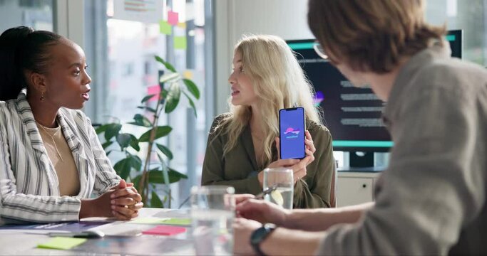 Woman, meeting and presentation for mobile app, software and show phone screen to team with ui. Business people, developer and ux designer group with smartphone, review and discussion at IT startup