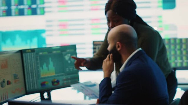 Diverse business analysts working together to evaluate costs and create a projection to deduct the future enterprise situation. Financial advisers specialists studying budget numbers. Camera A.