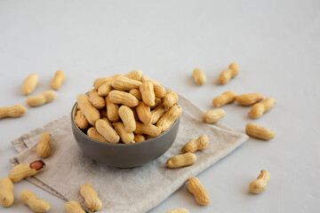 Organic Raw Peanuts in a Bowl, side view. Copy space.