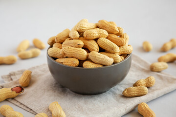Organic Raw Peanuts in a Bowl, side view.