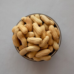 Organic Raw Peanuts in a Bowl, top view.