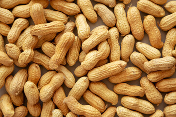 Organic Raw Peanuts on gray background, top view.