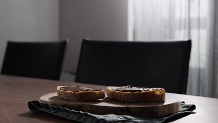 Rustic bread with organic hazelnut chocolate spread on olive board