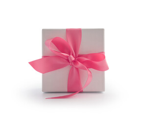 White gift box with pink ribbon bow isolated on white background