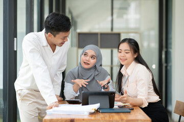 Asian businessmen, women and men Talk about new projects, presents at home office.