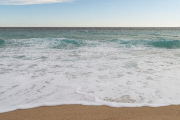 Empty sand beach on Mediterranean sea with horizon line vacation background