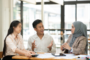Asian businessmen, women and men Talk about new projects, presents at home office.
