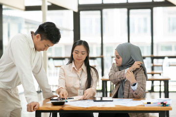 Asian businessmen, women and men Talk about new projects, presents at home office.