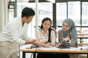 Asian businessmen, women and men Talk about new projects, presents at home office.