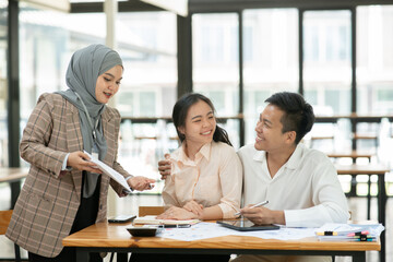 Asian businessmen, women and men Talk about new projects, presents at home office.