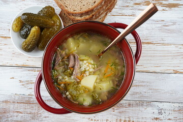 Soup with beef meat, pickled cucumbers and pearl barley.  Rassolnik- traditional Russian cuisine...