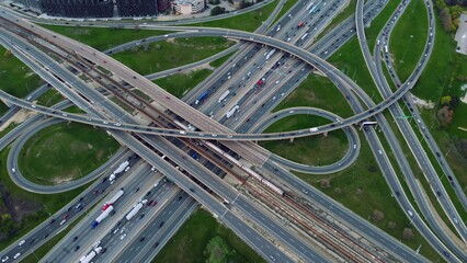 Urban rush: Aerial drone view of dense traffic on intertwining highways, showcasing bustling city...