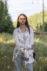 Portrait of a young beautiful long-haired girl outdoors.