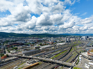 Aerial view of industrial district with skyline and cityscape at Swiss City of Zürich on a blue cloudy spring day. Photo taken May 24th, 2024, Zurich, Switzerland.