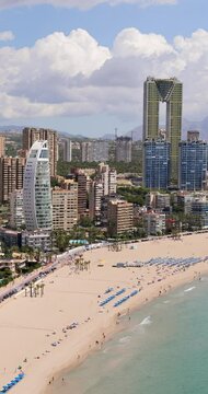 Portrait footage of the beautiful town of Benidorm in Spain showing the south beach Promenade and the tallest building in Benidorm The Intempo Sky Resort and Spa Hotel and the Delfin Tower