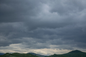 dark clouds with a gap of blue sky and white clouds