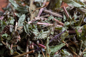 Dried mint leaves on a wooden background