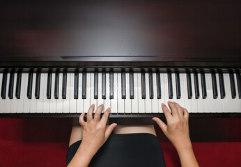 hand playing piano in nigh club and bokeh light on background on top view