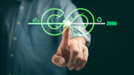 Fototapeta premium Businessman pointing towards an upward arrow, symbolizing the rise in carbon reduction efforts to combat climate change, emphasizing a sustainable, green economy.