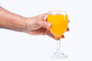 hand holding glass of orange or mango juice isolated on white background