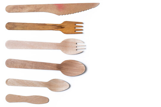 Wooden cutlery set arranged on white background with clipping path. - Powered by Adobe