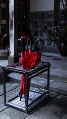Umbrella stand with a red umbrella plugged in