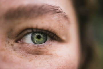 Close-up of a green eye with freckles and detailed features