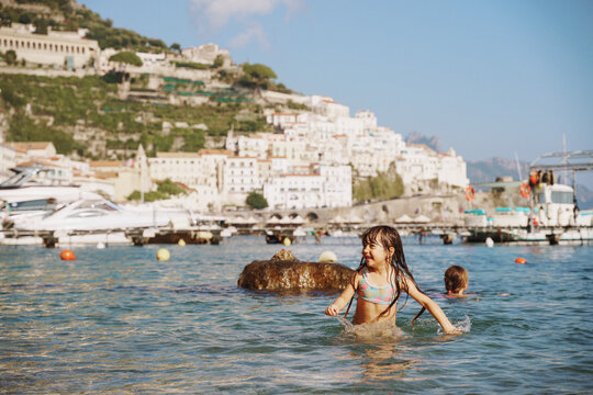 girls swimming in Amalfi coast beach, Italy